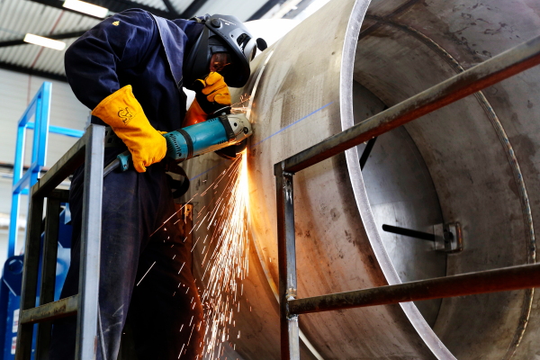 Grinding a weld with full PPE